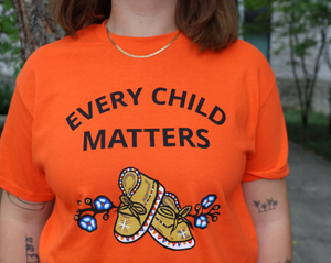 Orange T-Shirt with text "Every Child Matters" and moccasins 