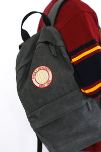 Grey backpack with circular Queens logo