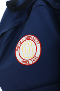 Close up of navy backpack with circular Queens logo