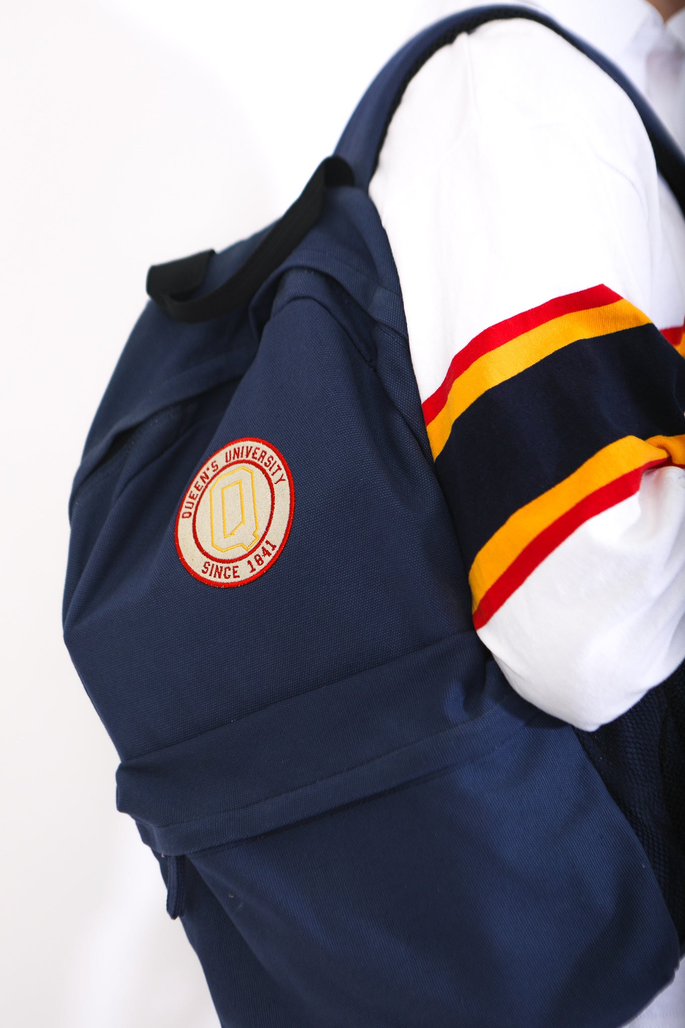 Navy backpack with circular Queens logo