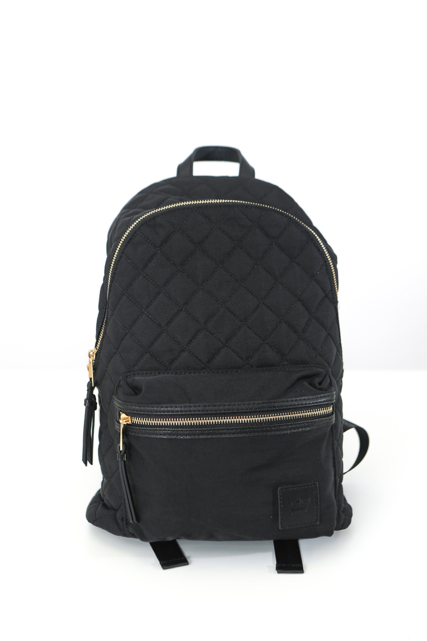 Back of black backpack with quilted pattern and gold zippers