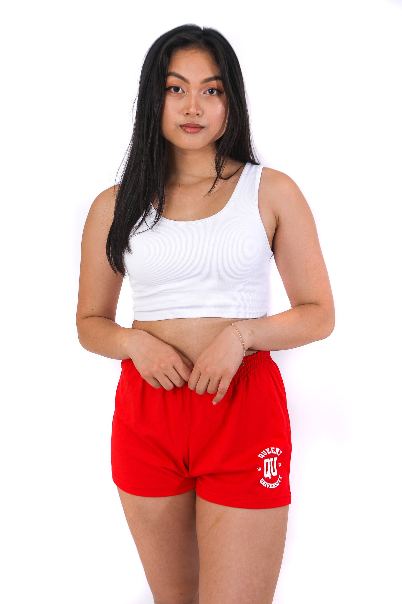 Red jersey knit cotton shorts with a stretchy waistband and a white QU on the front of the thigh