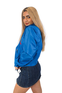 Side view of blue zip up rain jacket with red Queen's crest logo