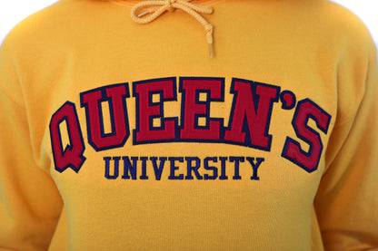 Close up of red Queen's logo on yellow sweater