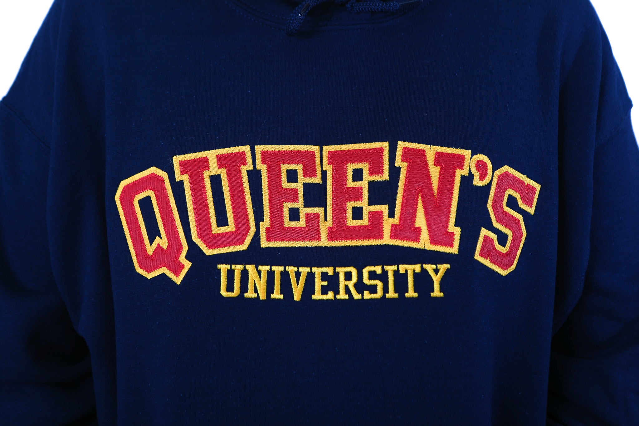 Close up of red Queen's logo on blue sweater