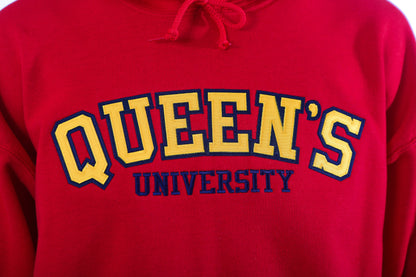 Close up of yellow Queen's logo on red sweater