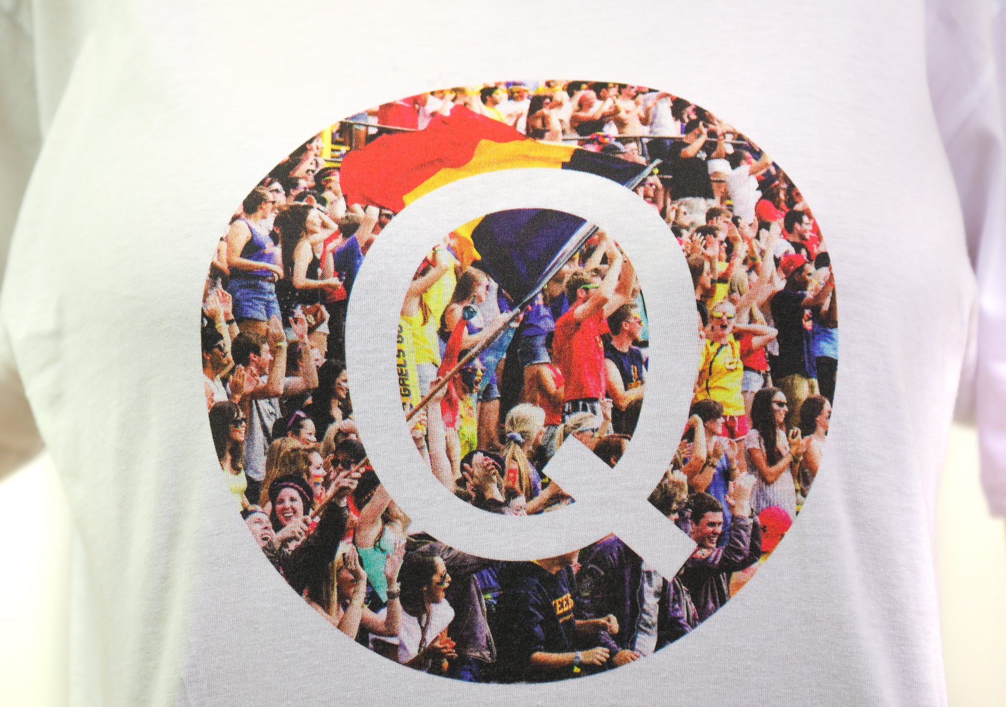 close up of white t-shirt with photograph of homecoming in the shape of a Q