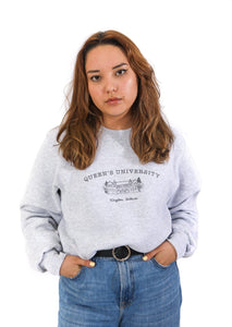 model wearing a grey crewneck sweatshirt with an illustration of ontario hall